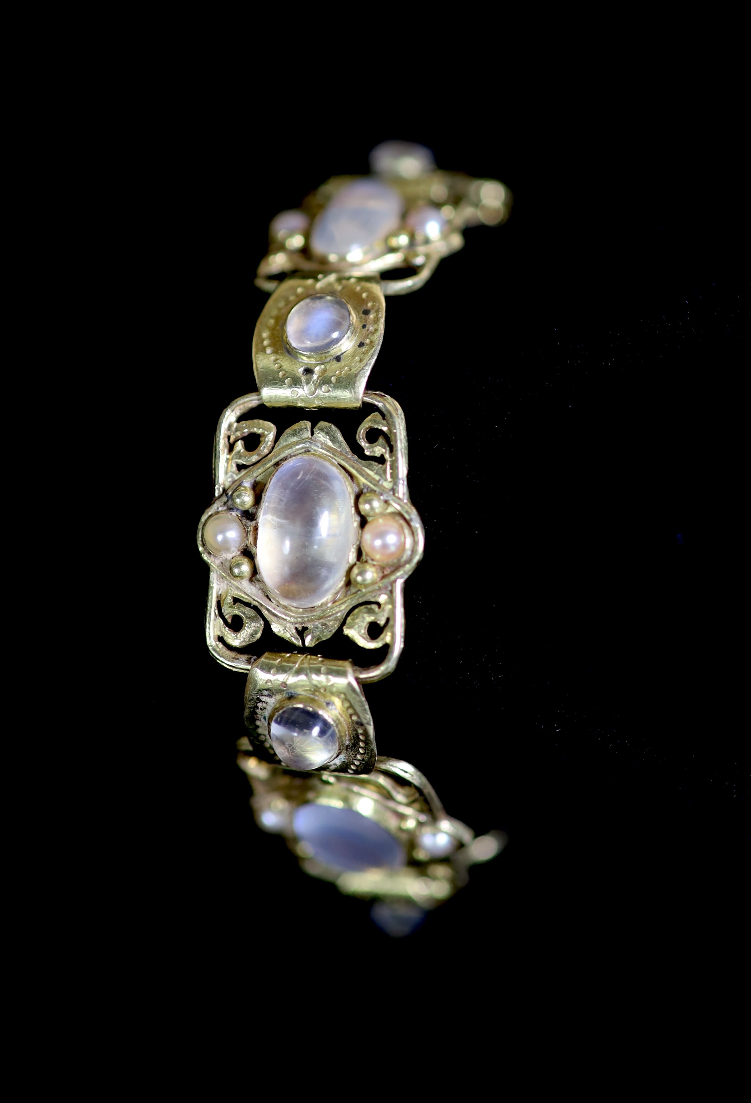 An early 20th century Arts & Crafts gold, cabochon moonstone and split pearl set bracelet